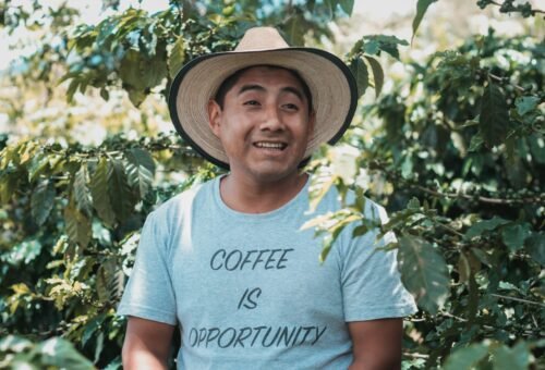 man in white crew neck t-shirt wearing brown straw hat