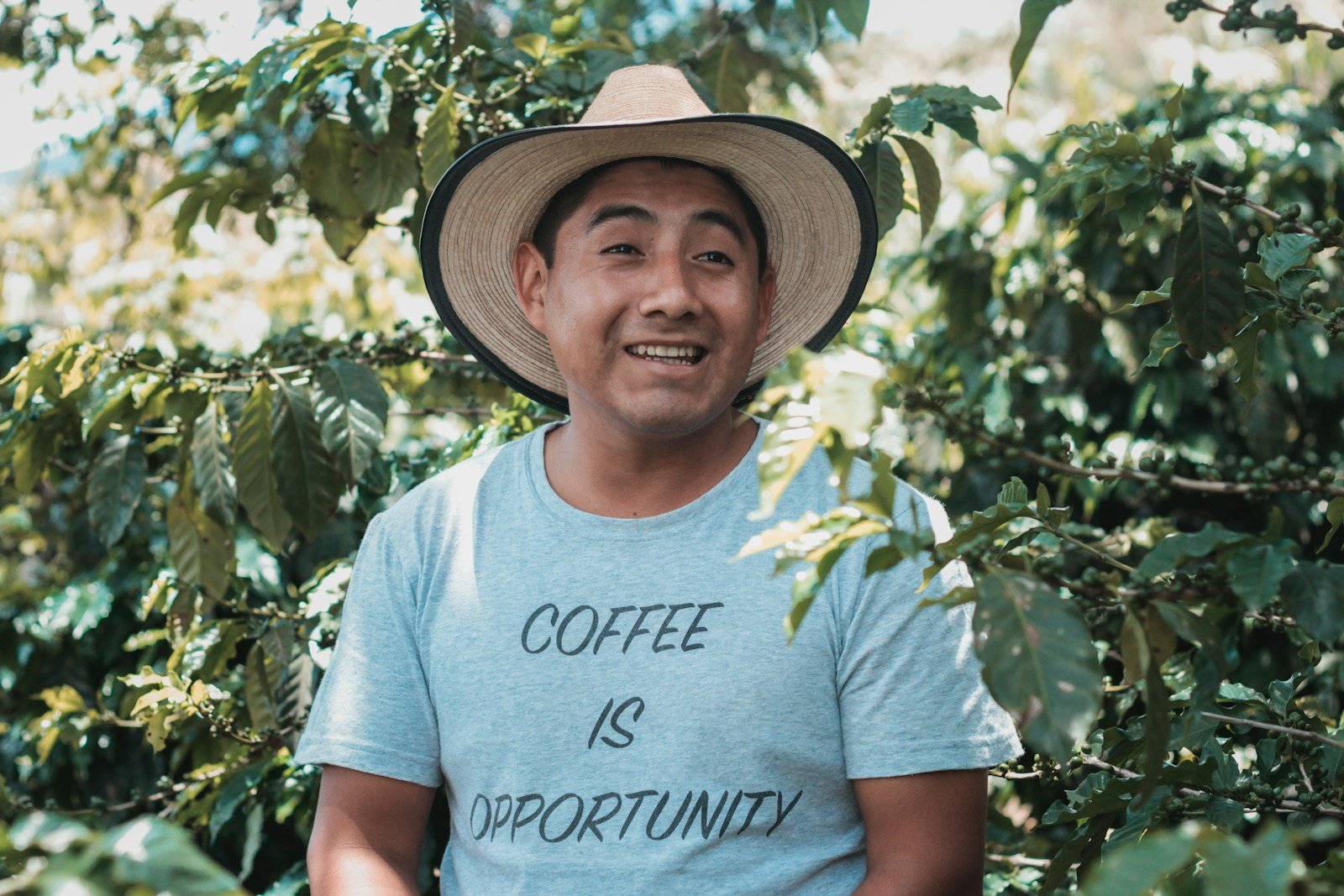 man in white crew neck t-shirt wearing brown straw hat